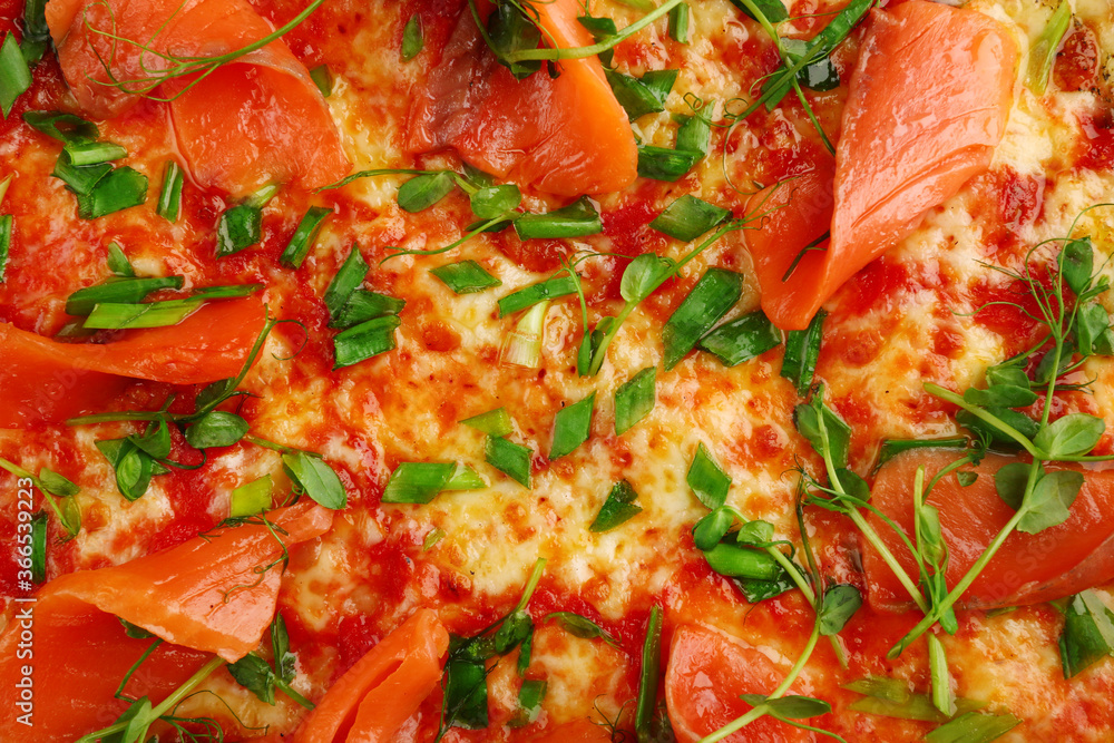 salmon pizza with green close up on gray concrete or stone table top view. pizza background salmon pizza with green close up on gray concrete or stone table top view. pizza background