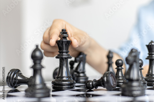 The company president is analyzing the game of chess in the office.