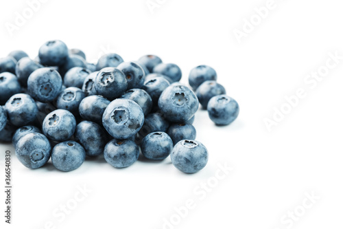 Blueberries are scattered on a white background. Free space, isolate. Studio light.