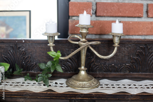 Vintage candlestick with candles in front wall.
