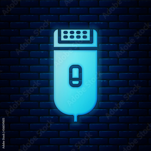 Glowing neon Electrical hair clipper or shaver icon isolated on brick wall background. Barbershop symbol. Vector Illustration.