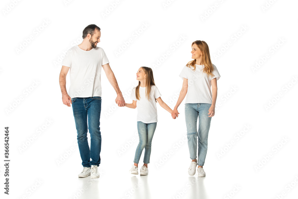 happy casual family holding hands while walking isolated on white happy casual family holding hands while walking isolated on white
