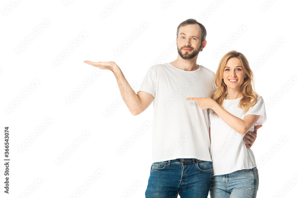 smiling adult couple in white t-shirts pointing with hand and finger aside isolated on white smiling adult couple in white t-shirts pointing with hand and finger aside isolated on white