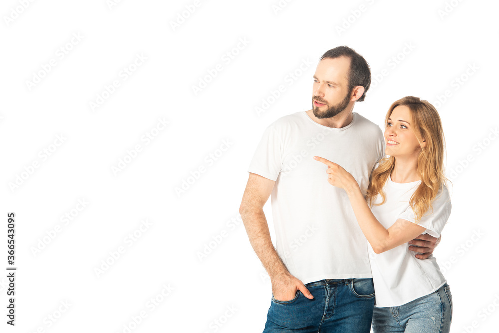 cheerful adult couple in white t-shirts pointing with finger aside isolated on white cheerful adult couple in white t-shirts pointing with finger aside isolated on white