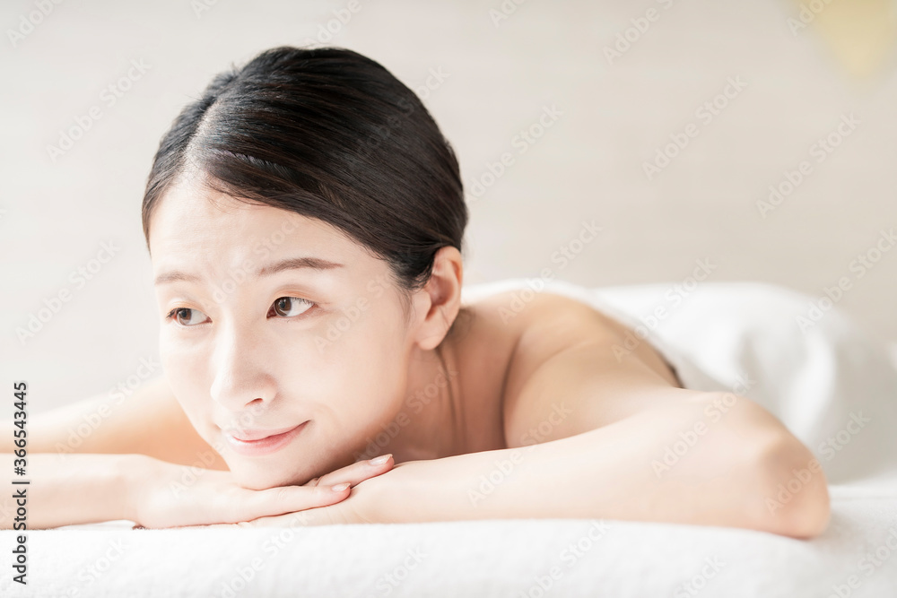 Young woman being massaged in a beauty salon with a bright atmosphere Young woman being massaged in a beauty salon with a bright atmosphere