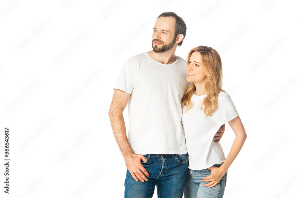 cheerful adult couple in white t-shirts embracing and looking away isolated on white cheerful adult couple in white t-shirts embracing and looking away isolated on white