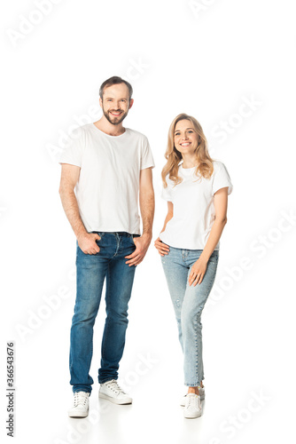 full length view of adult couple in white t-shirts and jeans posing isolated on white