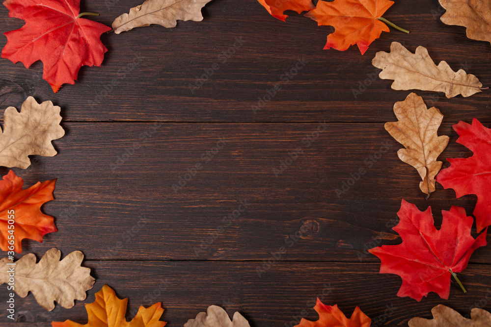 Autumn maple leaves on brown wooden table
