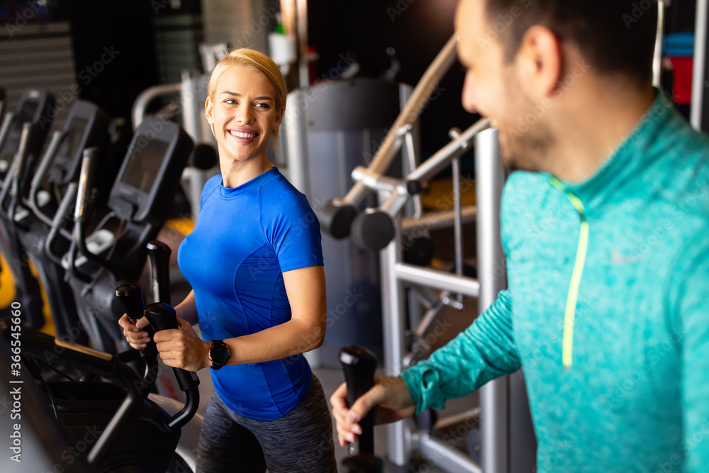 Obraz premium Happy people working out on treadmills in the gym