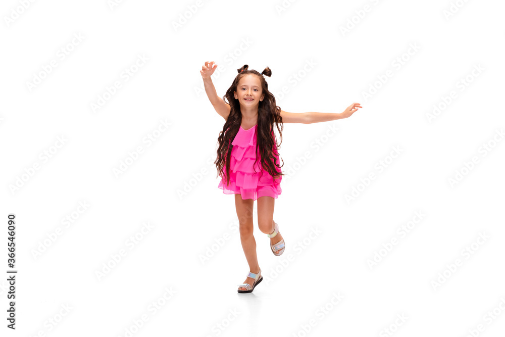 Happy child, little and emotional caucasian girl jumping and running isolated on white background. Looks happy, cheerful, sincere. Copyspace for ad. Childhood, education, happiness concept. Happy child, little and emotional caucasian girl jumping and running isolated on white background. Looks happy, cheerful, sincere. Copyspace for ad. Childhood, education, happiness concept.