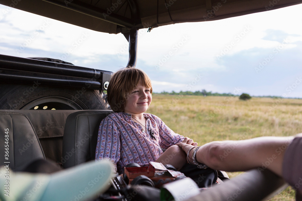 A five year old boy on safari, in a jeep in a game reserve A five year old boy on safari, in a jeep in a game reserve