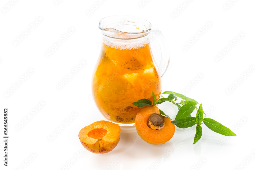 cold apricot compote in a glass decanter