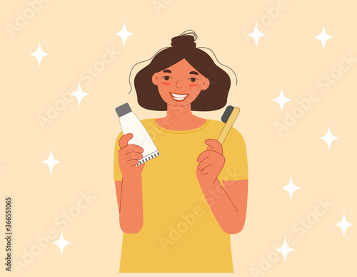 The girl is smiling and holding a toothpaste and toothbrush in her hands. The concept of care for the health of your teeth. Flat cartoon vector illustration.