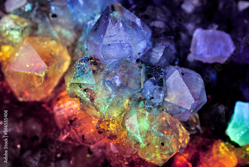 Iridescent natural transparent glossy and magic geometric Quartz crystal stucture through sun light.