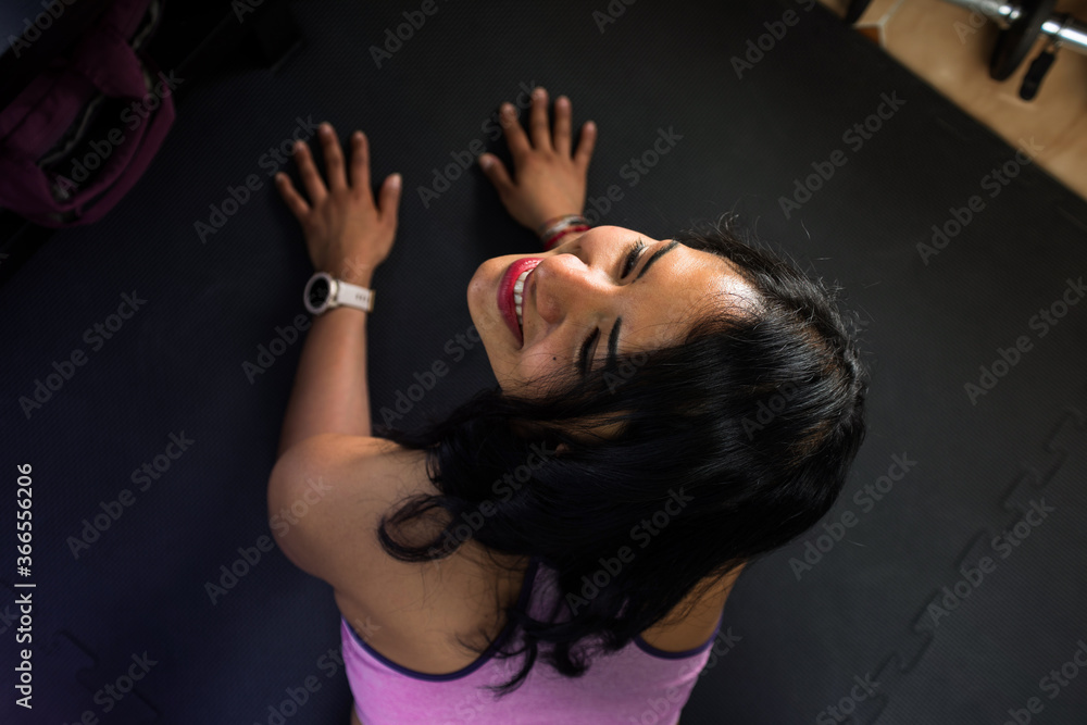 Fit woman doing yoga plank and smiling. Concept of young woman training at home. Fit woman doing yoga plank and smiling. Concept of young woman training at home.