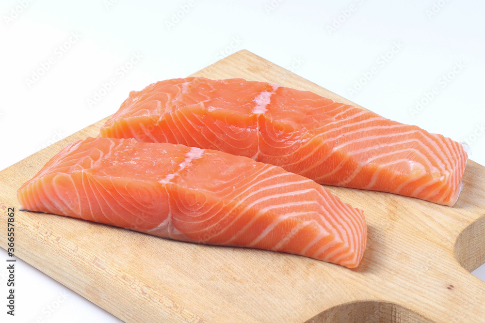 fresh salmon fillet on wooden board
