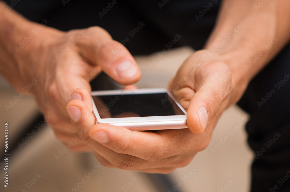 Close up, macro. Someone holds a smartphone in his hands and types a message. Close up, macro. Someone holds a smartphone in his hands and types a message.