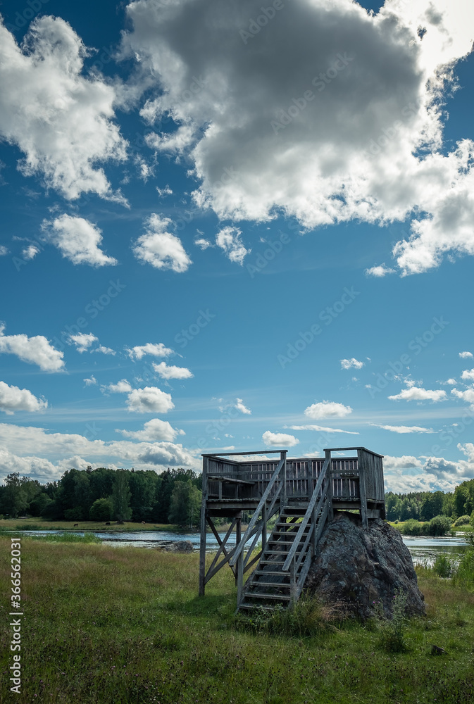 Bird watching tower beside lake in Sweden on a warm summer day