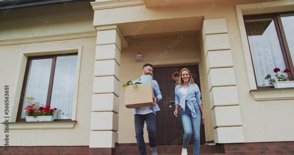 custom made wallpaper toronto digitalСouple leaving door of a newly sold house with things in a box and going to car. Family just sold the house. Moving to a new apartment of a young couple. Concept of lifestyle, happy family.