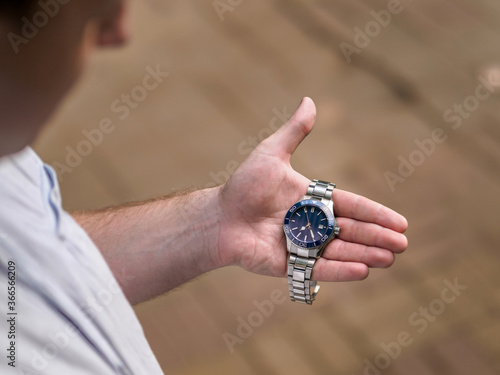Mechanical watch in the palm of a man's hand