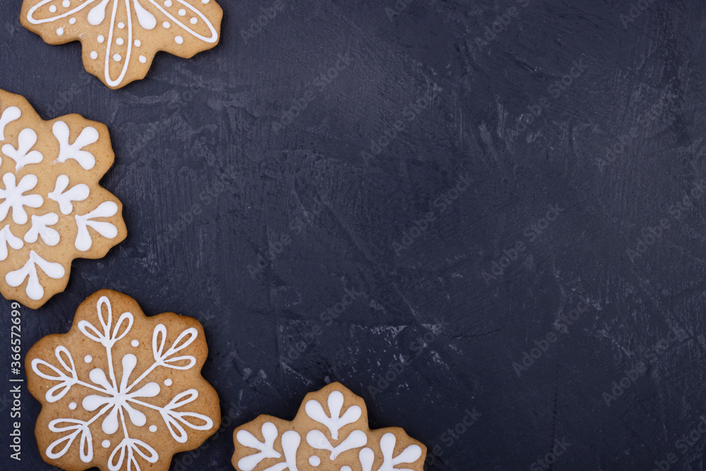 Christmas ginger cookies in the form of snowflakes on a dark background, top view Christmas ginger cookies in the form of snowflakes on a dark background, top view