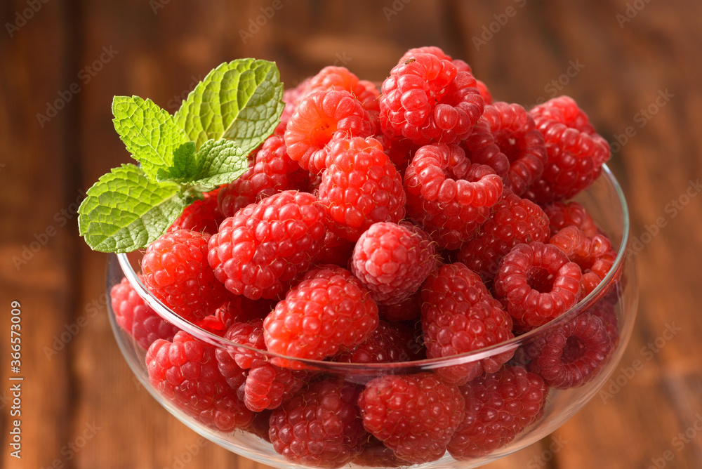 Raspberry and mint leaves in a glass. Raspberry and mint leaves in a glass.