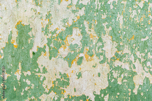 Old wall with peeling paint green