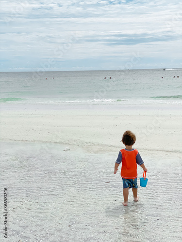 boy playing on the beach in summer in marco island florida beach 