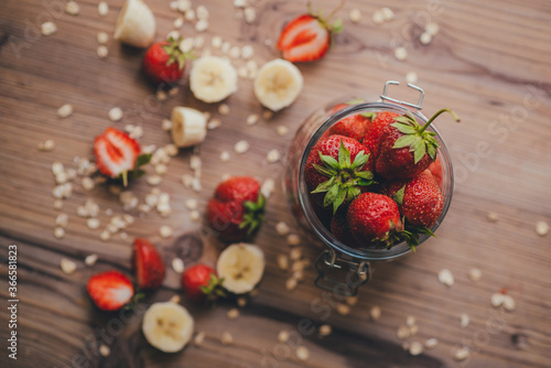 Strawberry with banana on wooden background