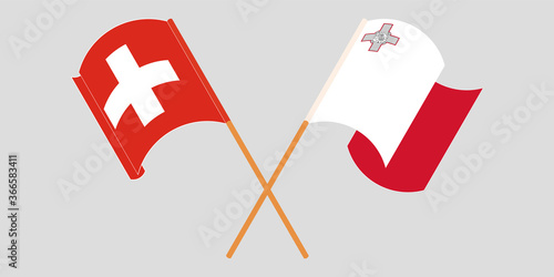 Crossed and waving flags of Malta and Switzerland