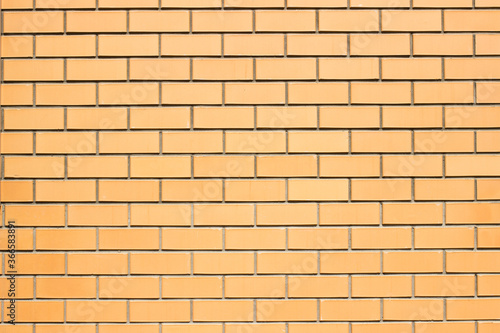 Brickwork background. New brick wall texture of orange color. Neat smooth brickwork.
