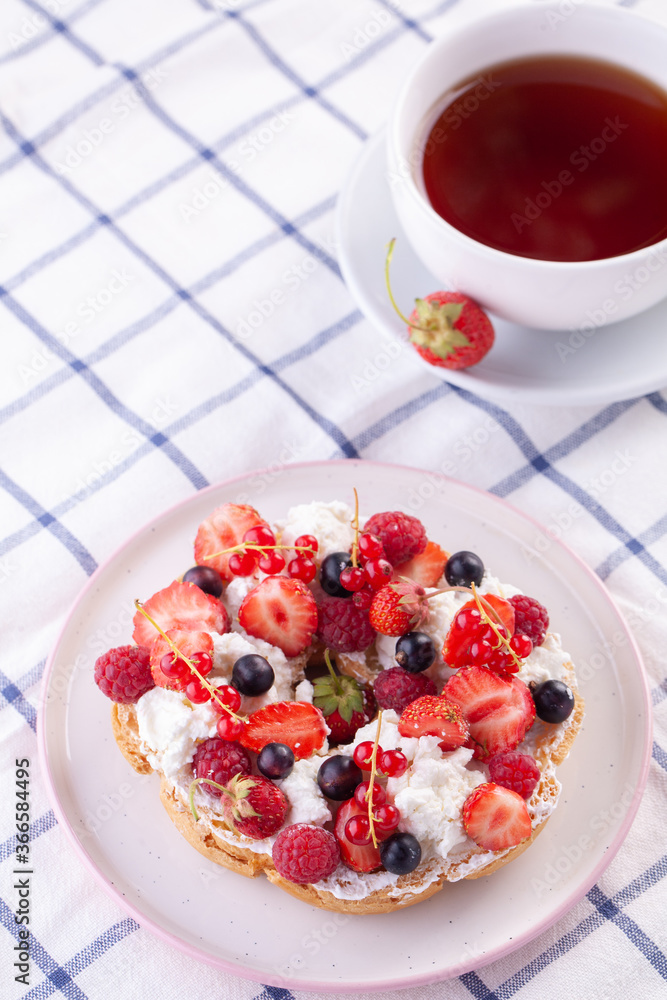 dessert with fresh berries on a white background. Sweet roll dessert with fresh berries on a white background. Sweet roll