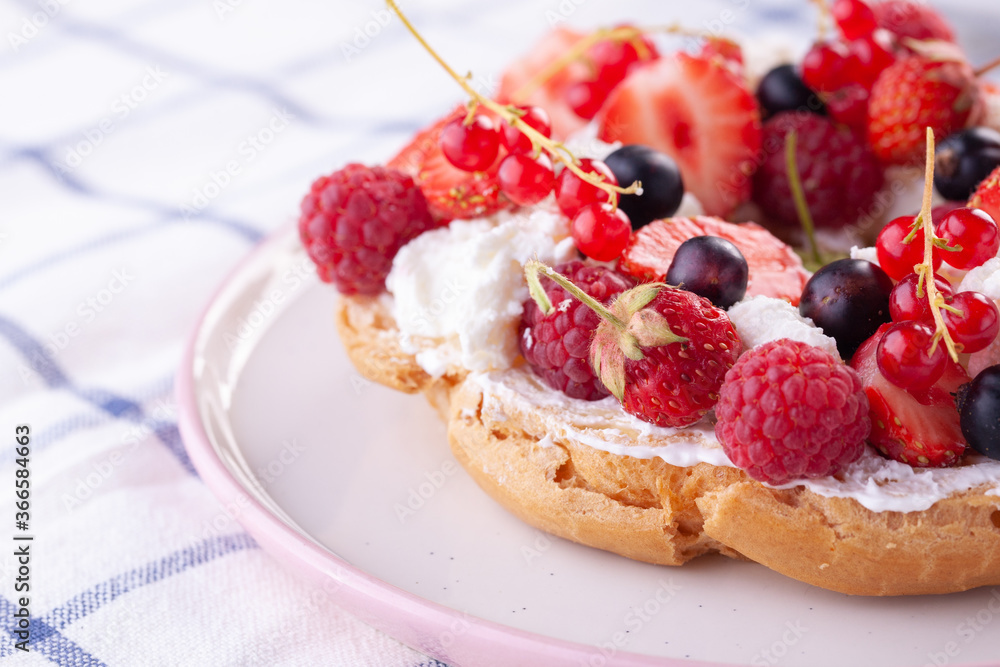 dessert with fresh berries on a white background. Sweet roll dessert with fresh berries on a white background. Sweet roll