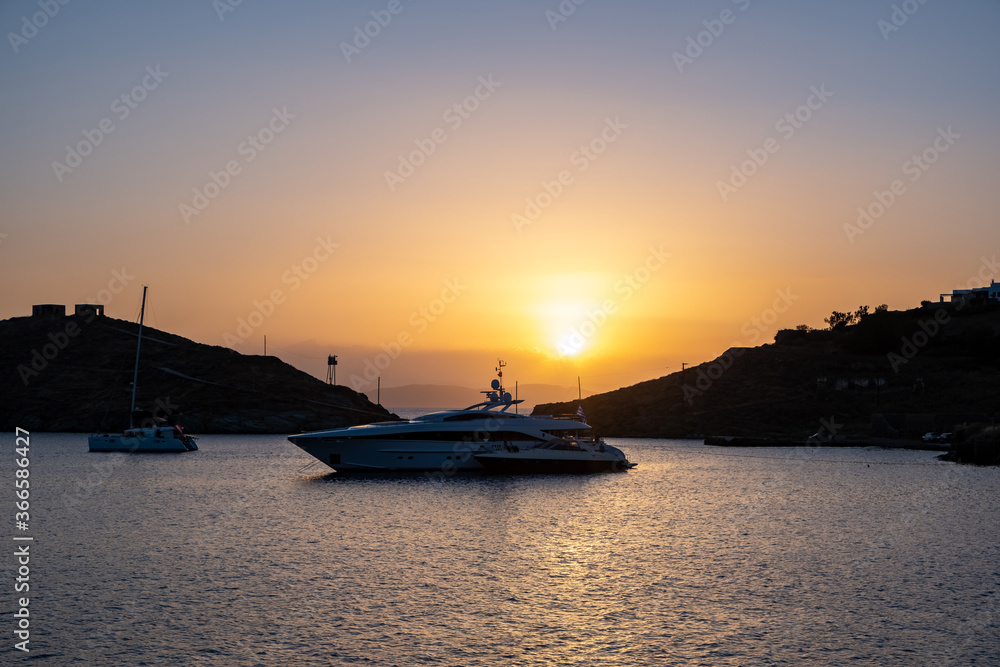 Yacht, luxury boat on calm sea at sunset in the Aegean sea, Greece, Kea island.