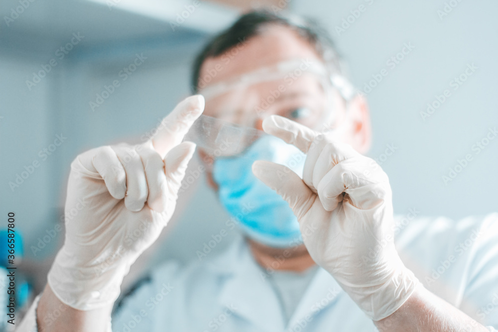 Bio chemistrist in mask studying sample Bio chemistrist in mask studying sample