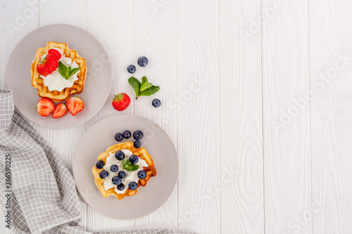 Traditional belgian waffles on white wood table background top view