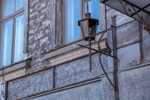 Old, broken lantern on the wall of a house in Tallinn