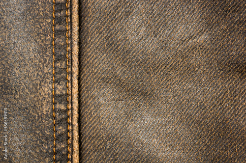 clothing items stonewashed cotton fabric texture with seams, clasps, buttons and rivets, macro