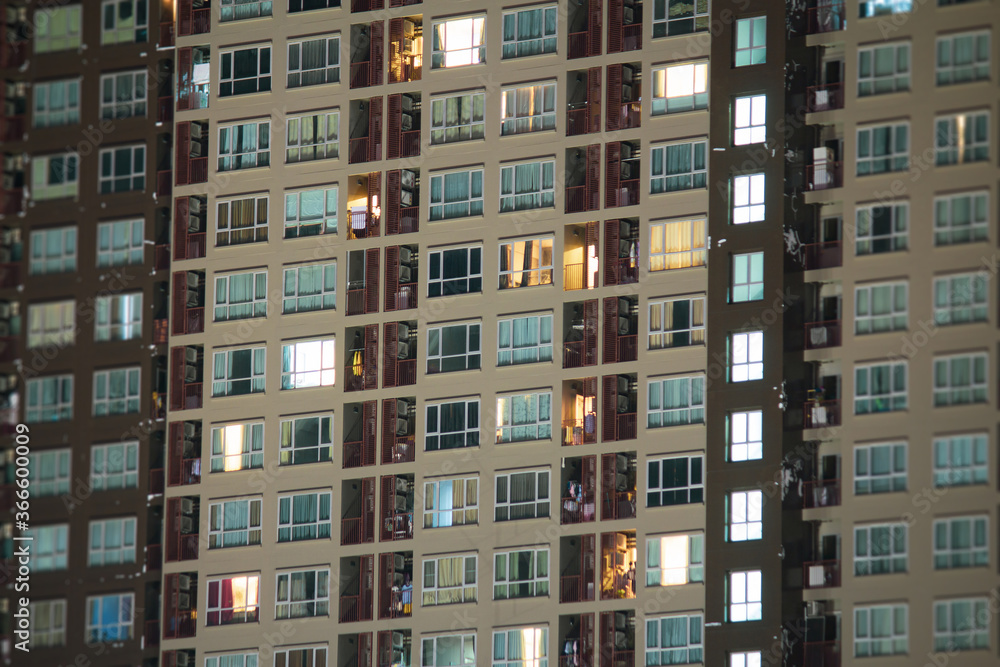 Apartment windows at night.  Urban city living vibe.