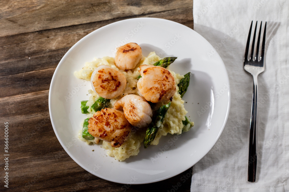 Seared scallops over asparagus risotto