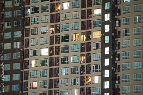 Apartment windows at night. Urban city living vibe.