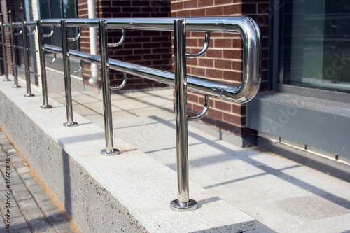 Stainless Steel Railings. Chromed metal railings. Shiny chrome metal fencing and railings. Handrail, outdoor.