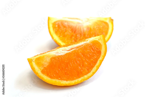 Two slices of orange on a white background
