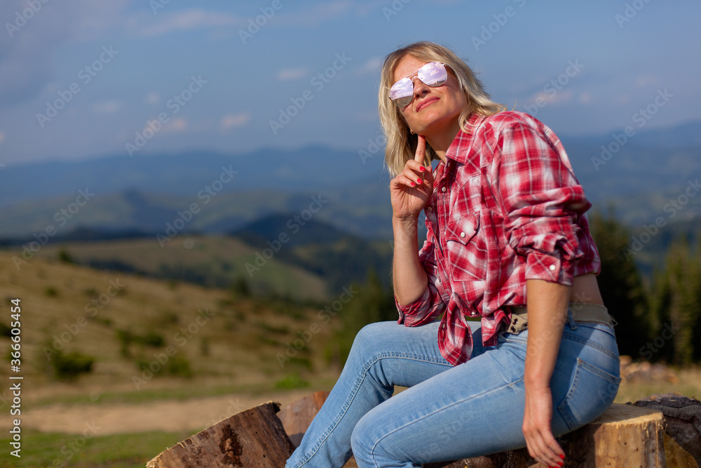 cute girl in denim clothes in the carpathian mountains