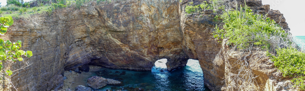 Panoramic view of natural caves created by the caribbean sea. Le trou de david.