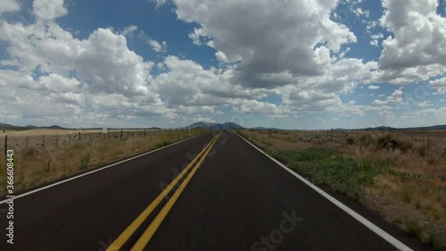 4K driving plate POV drive on a rural country road  in Prescott, Arizona with epic clouds in the sky. photo