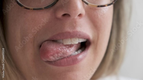Woman’s mouth and tongue close up. Smiling tongue out and white teeth
