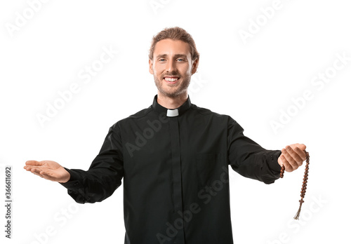 Handsome priest on white ba...