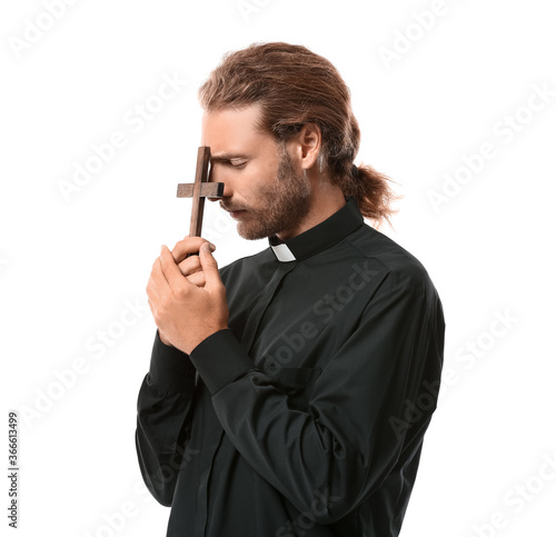 Handsome praying priest on ...