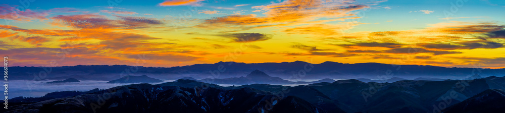 Panoramic sunset in the Mountains with Clouds, Fog